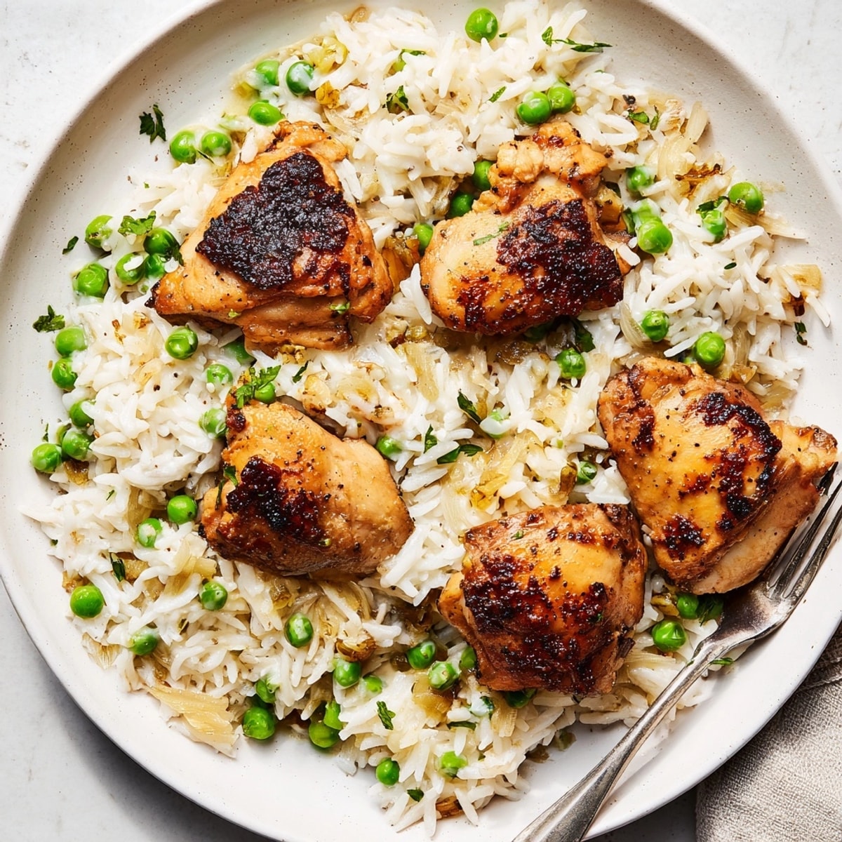 A comforting bowl of One-Pot Creamy Lemon Chicken and Rice, steaming with zesty lemon aroma and creamy texture.