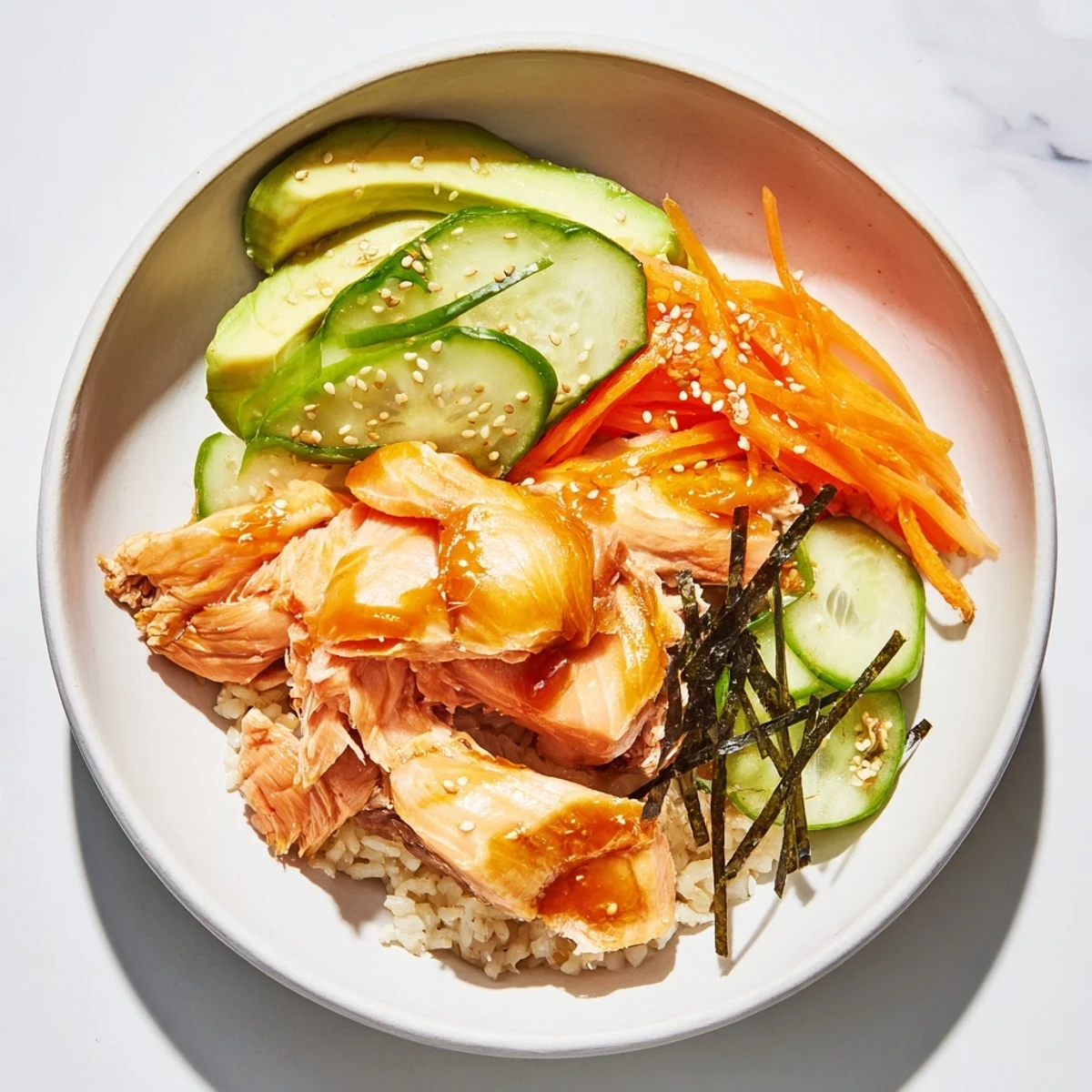 Enjoy a delicious Japanese-Style Salmon & Chicken Rice Bowl, with fluffy rice and savory marinated proteins.