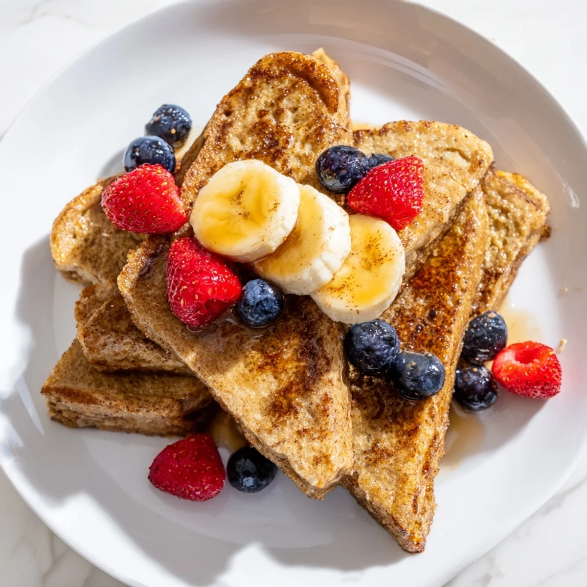 Golden-brown Protein French Toast, topped with fresh berries, promises a delicious, high-protein breakfast.