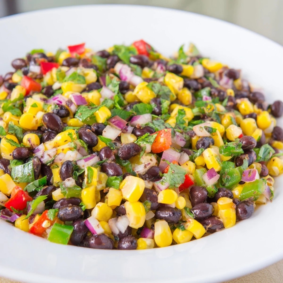 Vibrant Cowboy Caviar Salad boasts colorful peppers, black beans and a zesty lime dressing.