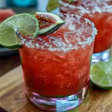 Best Guava Margarita cocktail with a Tajín rim, vibrant pink hue, lime wheel, and guava slice garnish, served in a rocks glass.