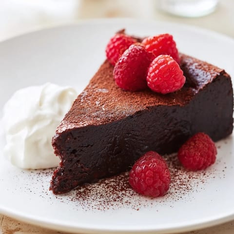 This fudgy Decadent Flourless Chocolate Cake showcases a deep, dark chocolate flavor and a smooth texture.