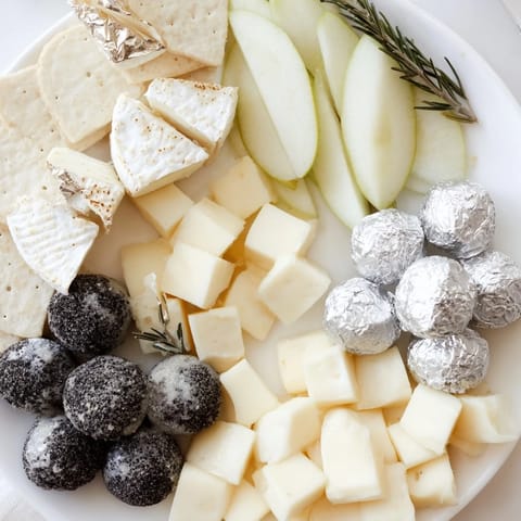 The Silver Screen cheese board features a glamorous array of cheeses with silver-covered chocolates ready to enjoy.