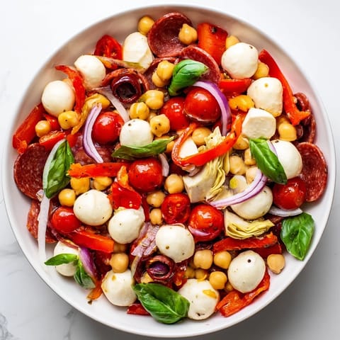 This Antipasto Chickpea Salad showcases a medley of Italian flavors, tossed in a tangy vinaigrette.