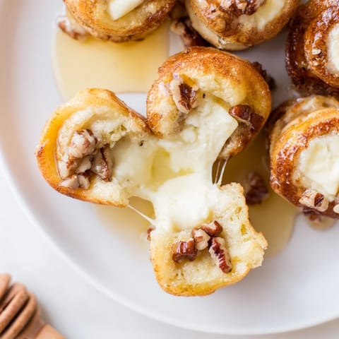 These savory Pancake Brie Bites feature a soft, golden exterior with creamy, melted brie at the center.