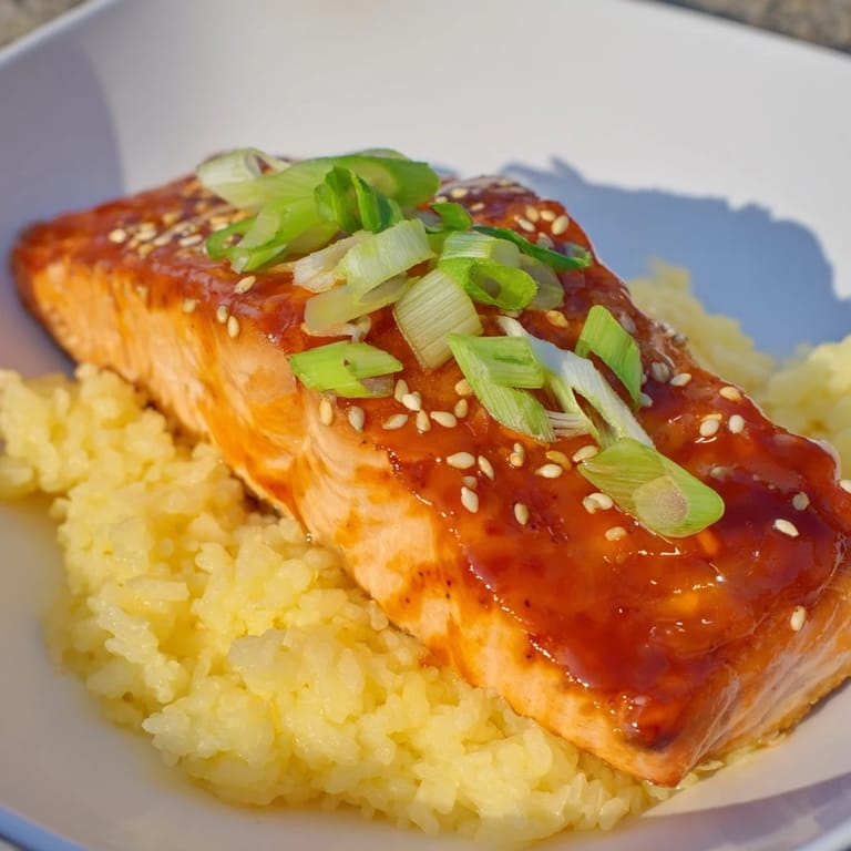 Beautiful plated Sticky Orange Salmon, glistening and savory, offering a delightful flavorful meal.