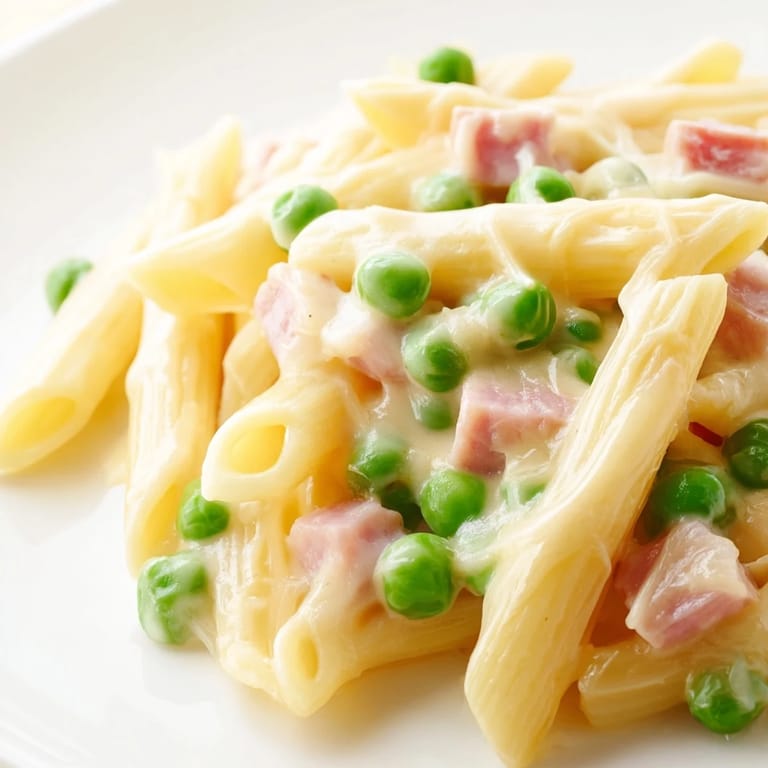 Hearty Spring Pea & Ham Pasta featuring bright green peas, al dente penne, and golden ham coated in a silky cream sauce.