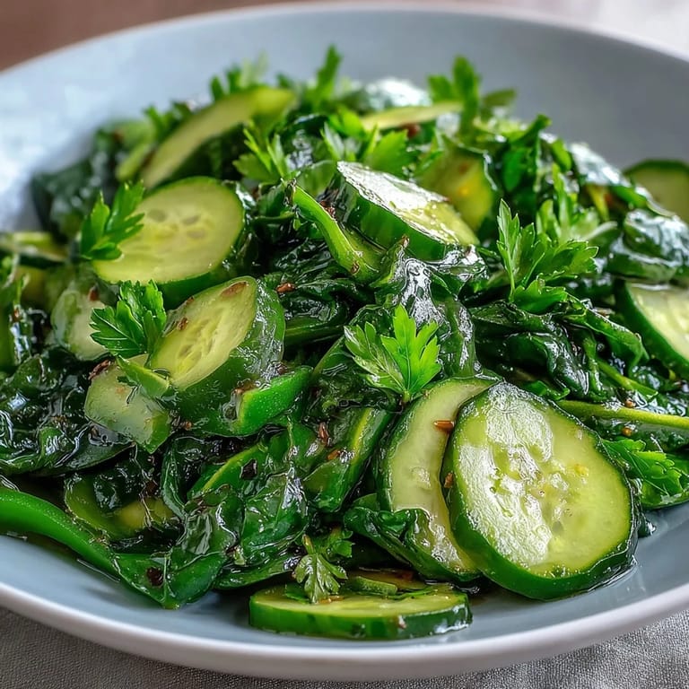 A refreshing Glowing Green Salad piled high, perfect for a healthy and delicious meal.