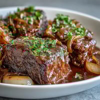 Savory Crock Pot French Onion Pot Roast with tender beef and gooey melted Gruyere in a slow cooker.